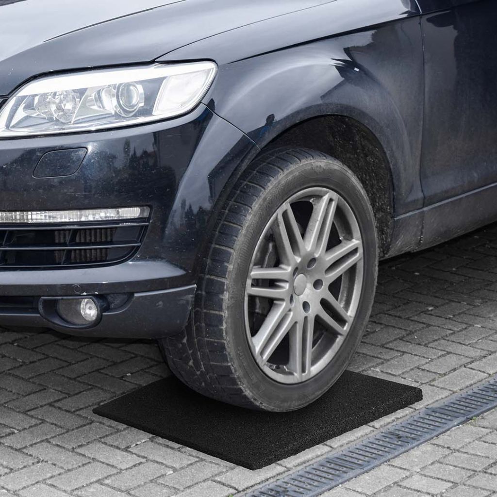 Car stands on rubber tire protectors.